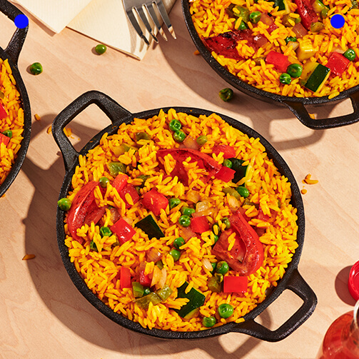 A table displaying four pans of various dishes
