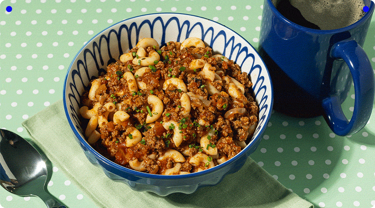 bowl pasta beef sauce green napkin mug