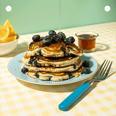 Blueberry pancakes drizzled with syrup