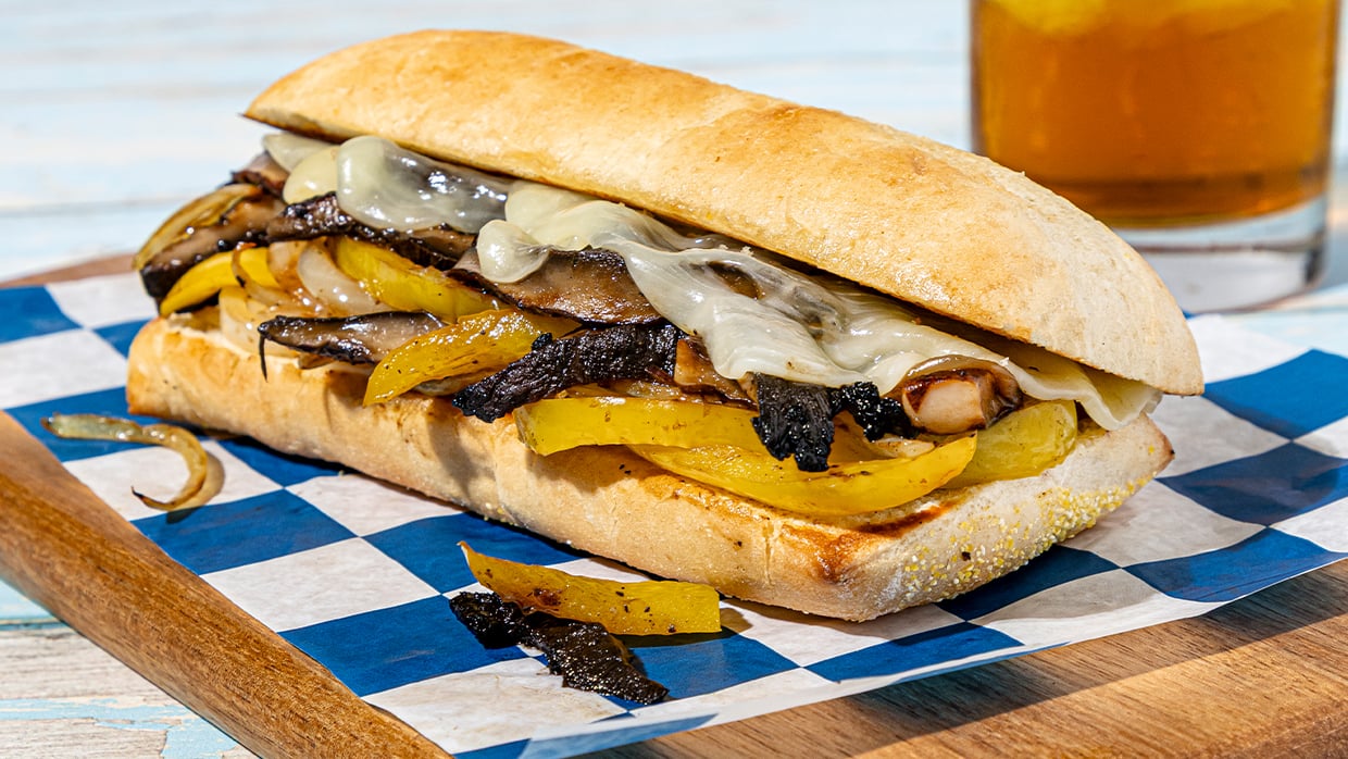 A sandwich placed on a piece of paper, showcasing its layers and ingredients.