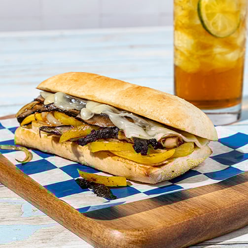 A sandwich placed on a piece of paper, showcasing its layers and ingredients.