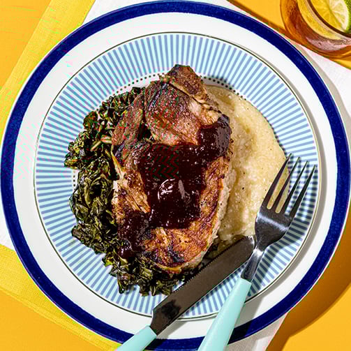 A plate of food sits on a bright yellow table, showcasing a colorful and appetizing meal.