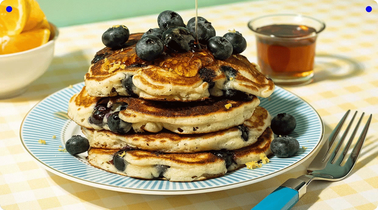 Blueberry pancakes drizzled with syrup