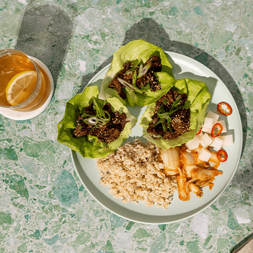 Ginger-soy beef with brown rice, kimchi, pickled daikon and lettuce leaves