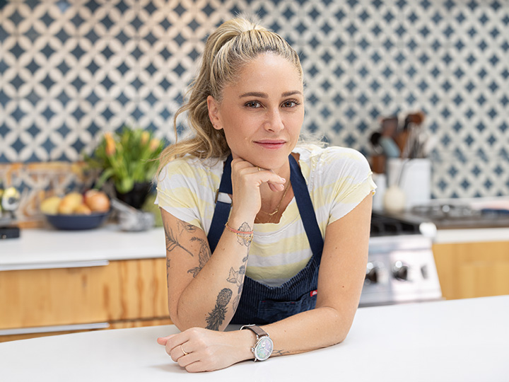Young blonde woman posing in a kitchen