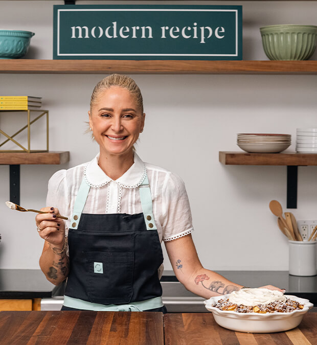 Brooke Williamson smiling while presenting a dessert dish