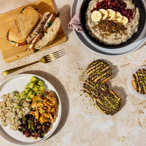 variety of food plates including a sandwich, rice plate, oatmeal with fruit and cookies