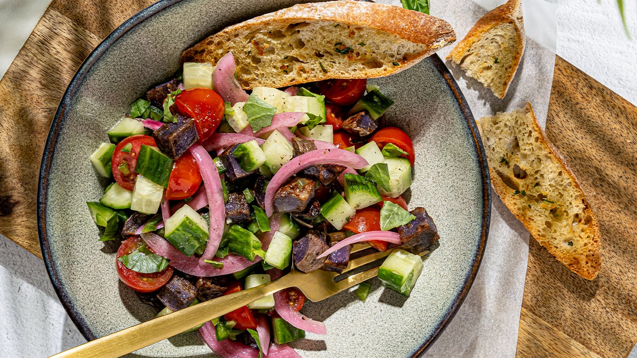 A plate of food featuring a slice of bread and a fork placed beside it.