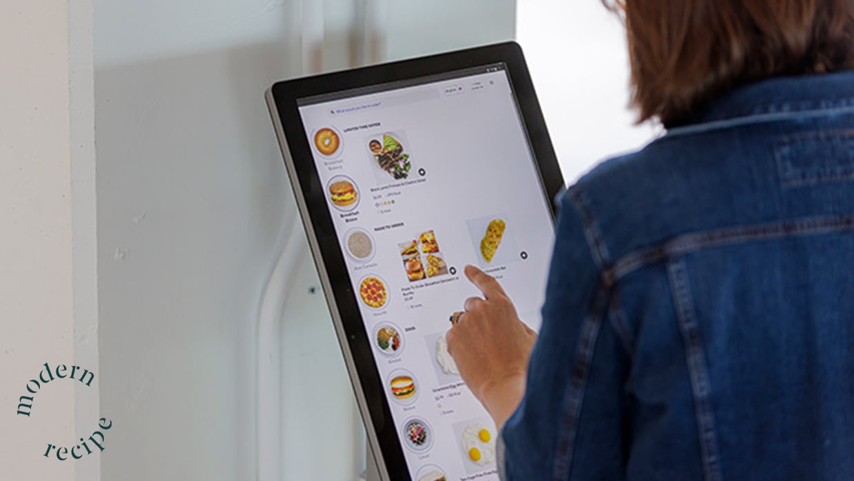 person choosing food on touchscreen
