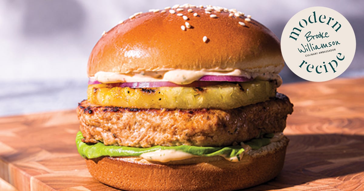Hawaiian salmon burger on a seeded bun with grilled pineapple and sweet soy aioli.
