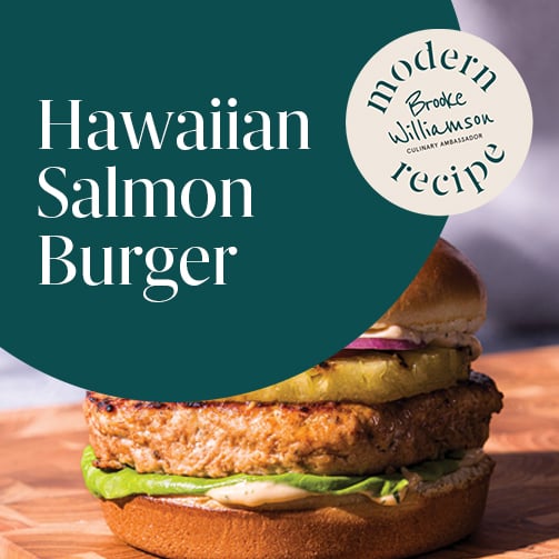 Hawaiian salmon burger on a seeded bun with grilled pineapple and sweet soy aioli.