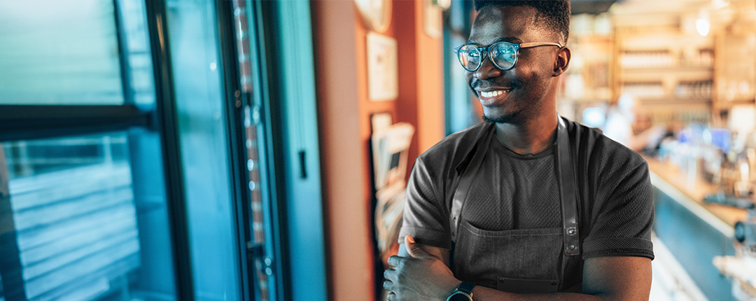 black male chef with glasses smiling