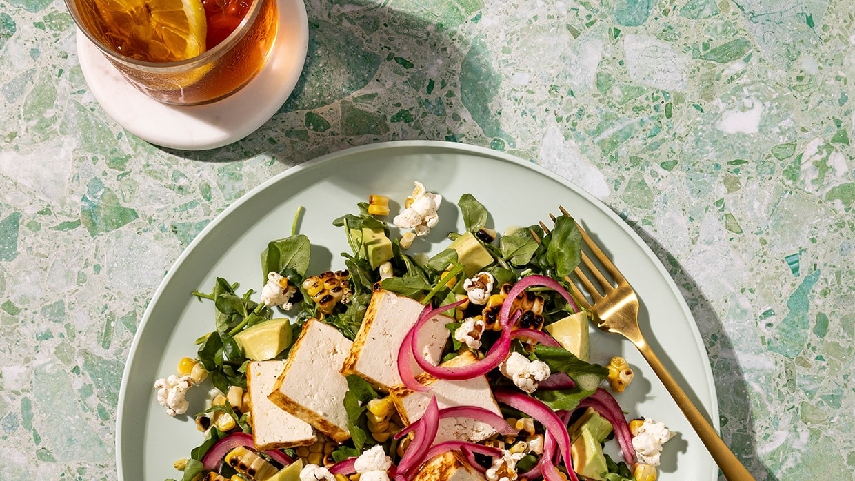 Seared tofu, charred corn, avocado, and pickled onion with celery salt popcorn.