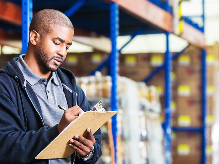 Man taking notes in a factory