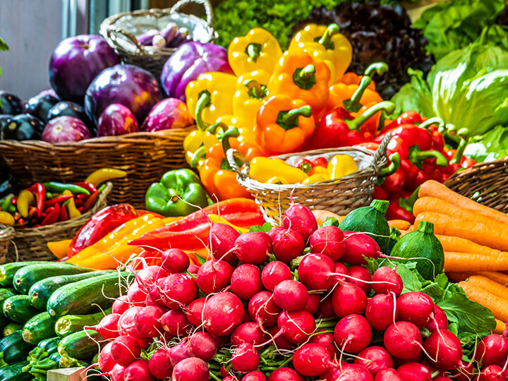 A vibrant assortment of fresh vegetables arranged on a large display, showcasing various colors and types.