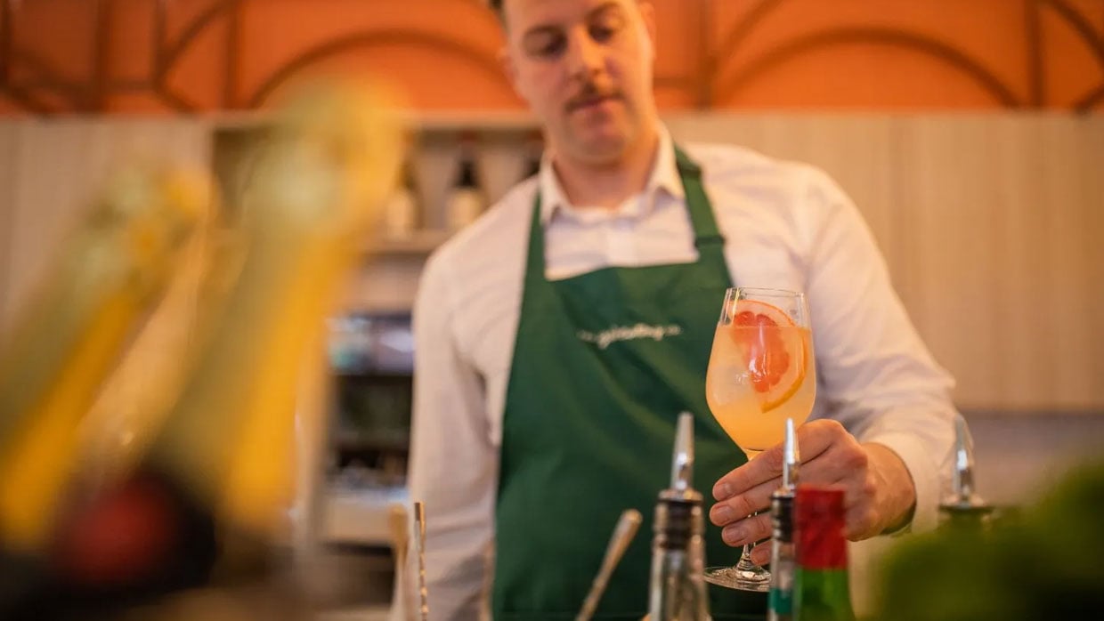 a man finishing a cocktail