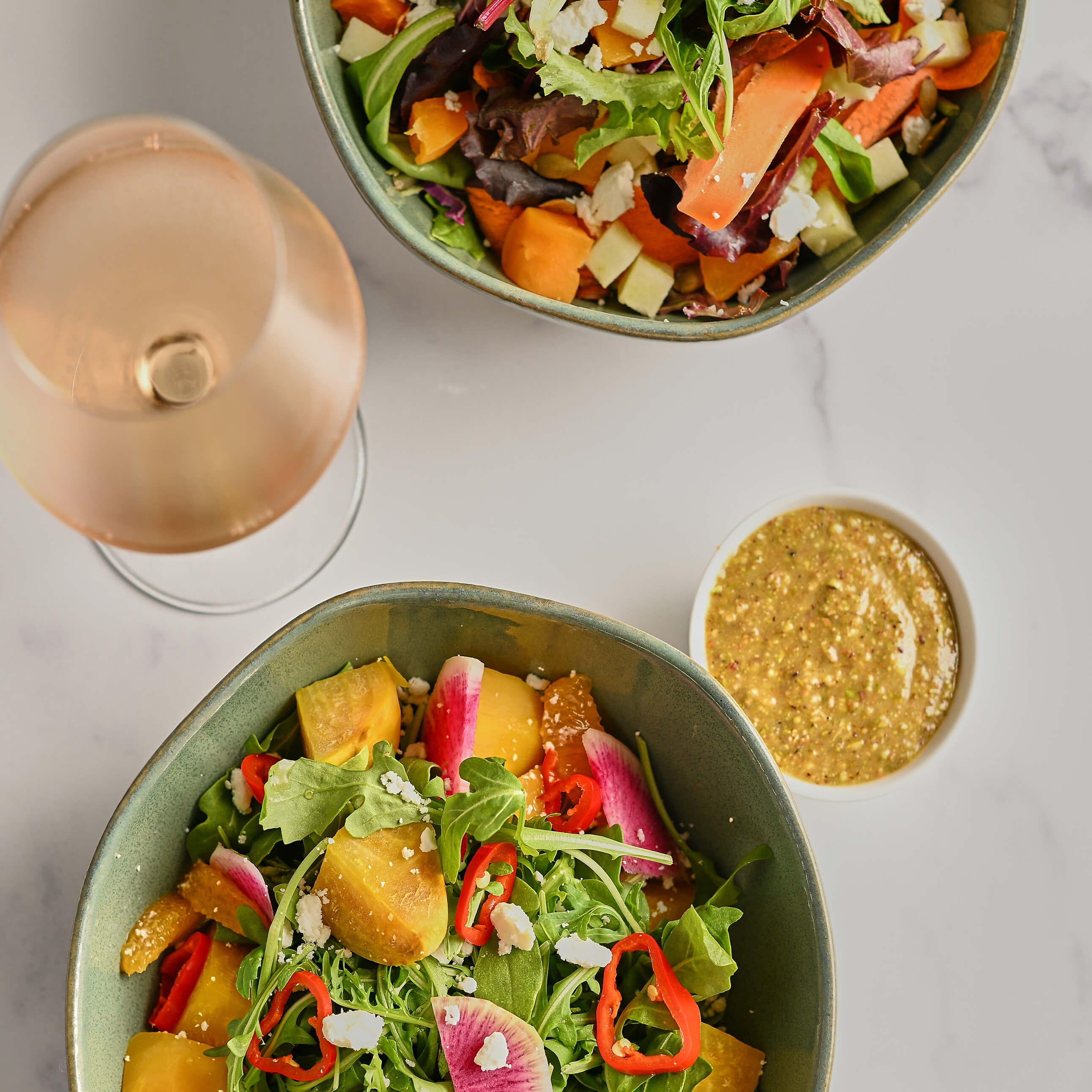 granite counter top with salads and drinks.