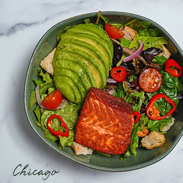 Salmon salad with avocado and a variety of vegetables