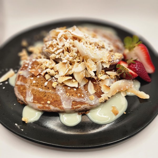 A plate featuring fluffy pancakes topped with fresh strawberries, creating a delightful breakfast presentation.
