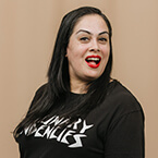 Photo of a female chef in a black t-shirt smiling