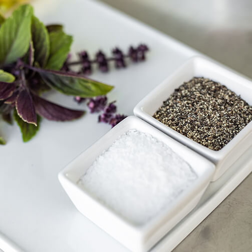 salt and pepper in small white containers