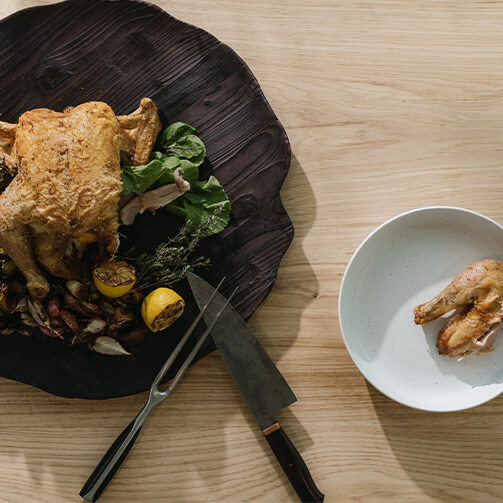 Roasted chicken with sauteed vegetables on a dark plate