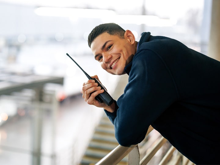 happy men smiling and talking by a radio