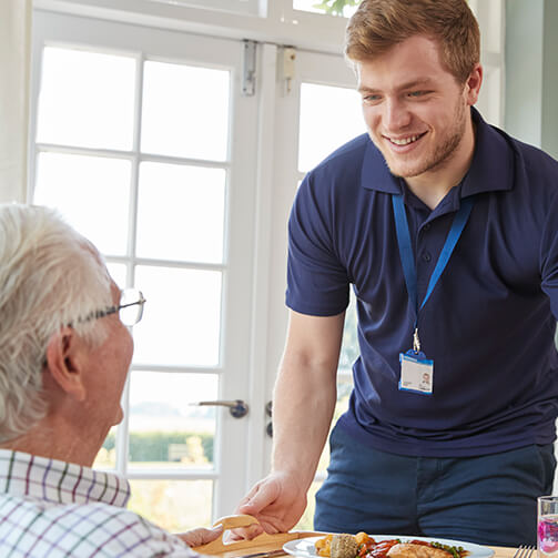 young man serving older man