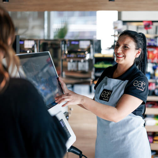 woman at self-service checkout