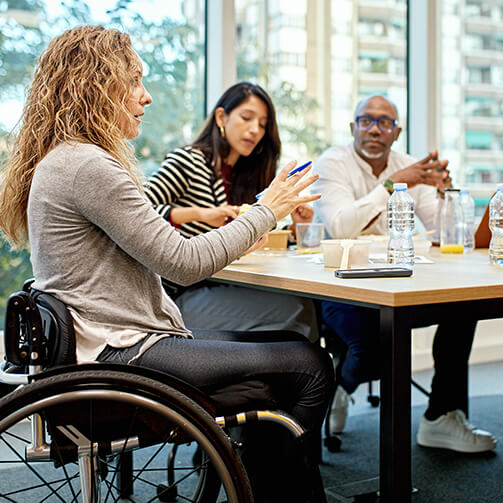 woman in wheelchair in meeting at office