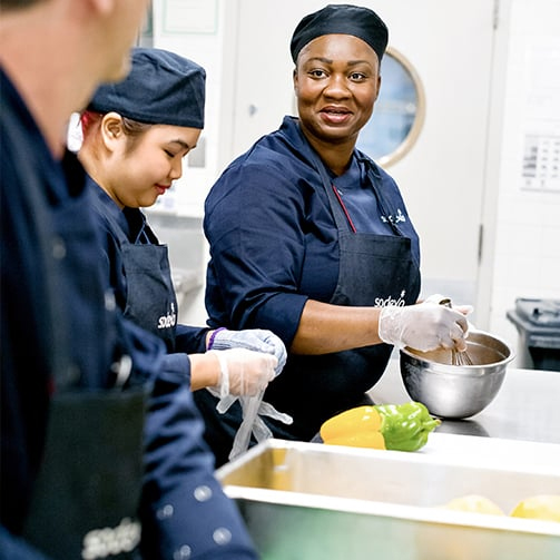 Chefs in the kitchen preparing dishes