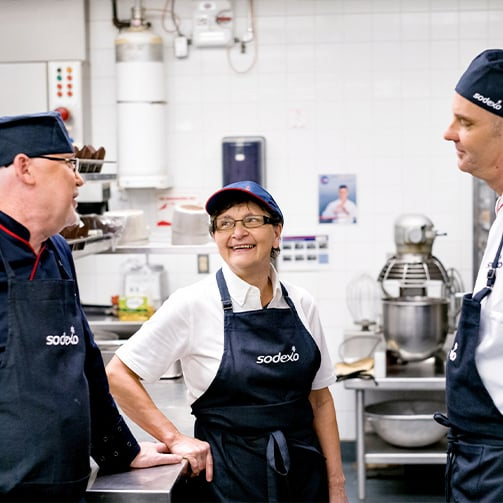 chefs in the kitchen smiling