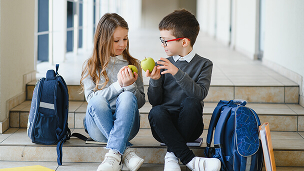 two kids  sharing food