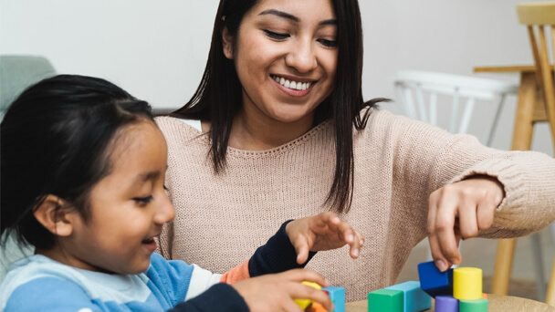 woman and girl playing with toys