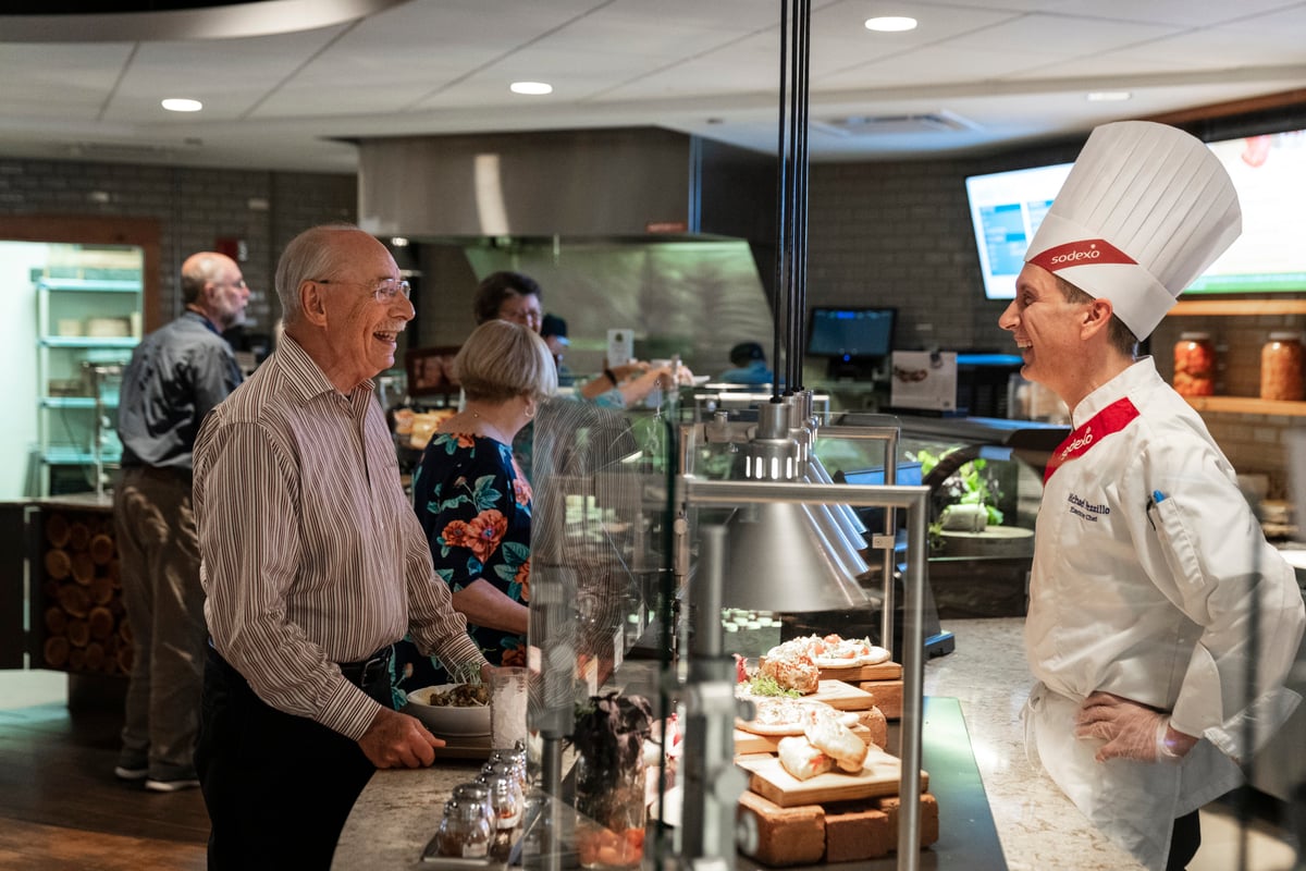 old man talking with a chef