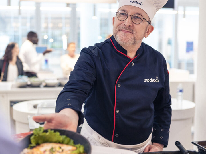 male chef delivering dish