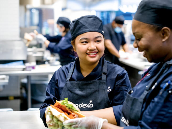 two female chefs working and smiling