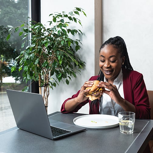 woman eating and working