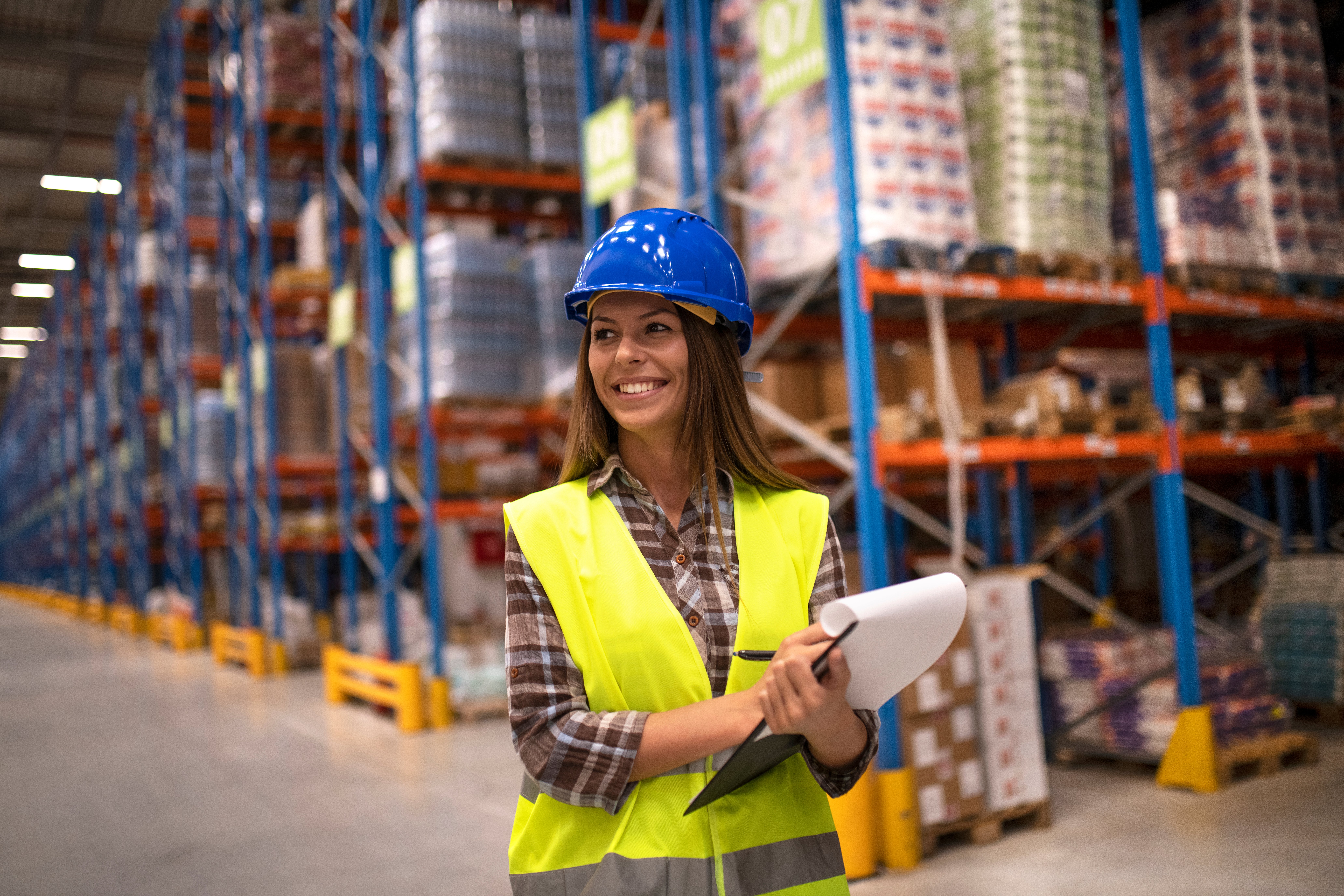 portrait-female-worker-distribution-warehouse-looking-aside