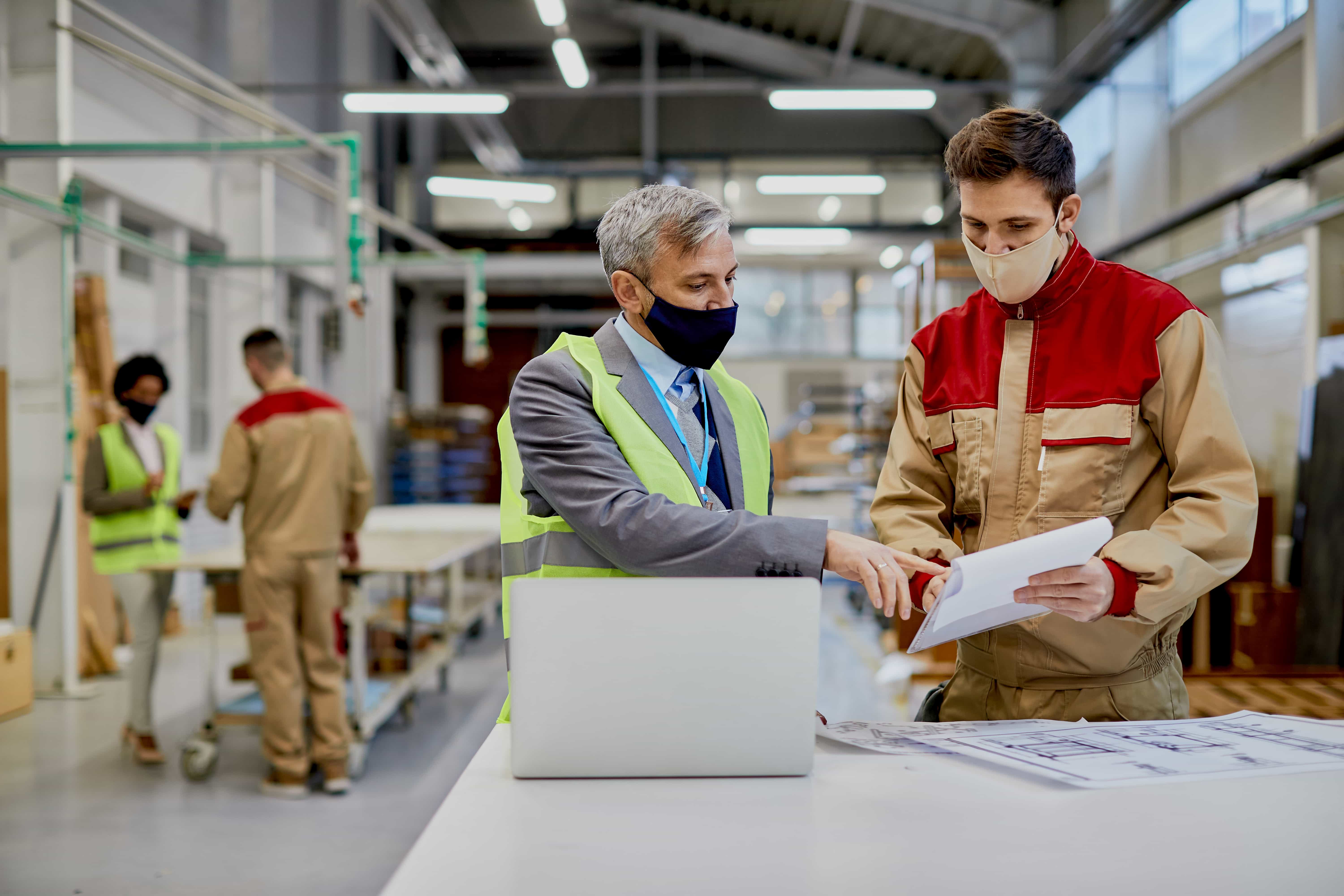 mid-adult-engineer-male-worker-wearing-face-masks-while-examining-paperwork-woodworking-factory (1)