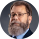 Portrait of a person, wearing glasses and a suit.