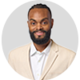 Person in a beige suit on a gray background.