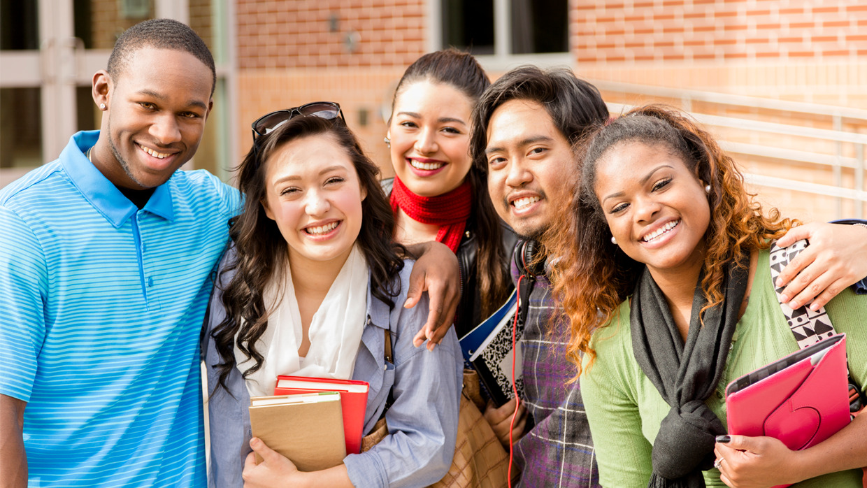 A diverse group of friends smiling together for a photo