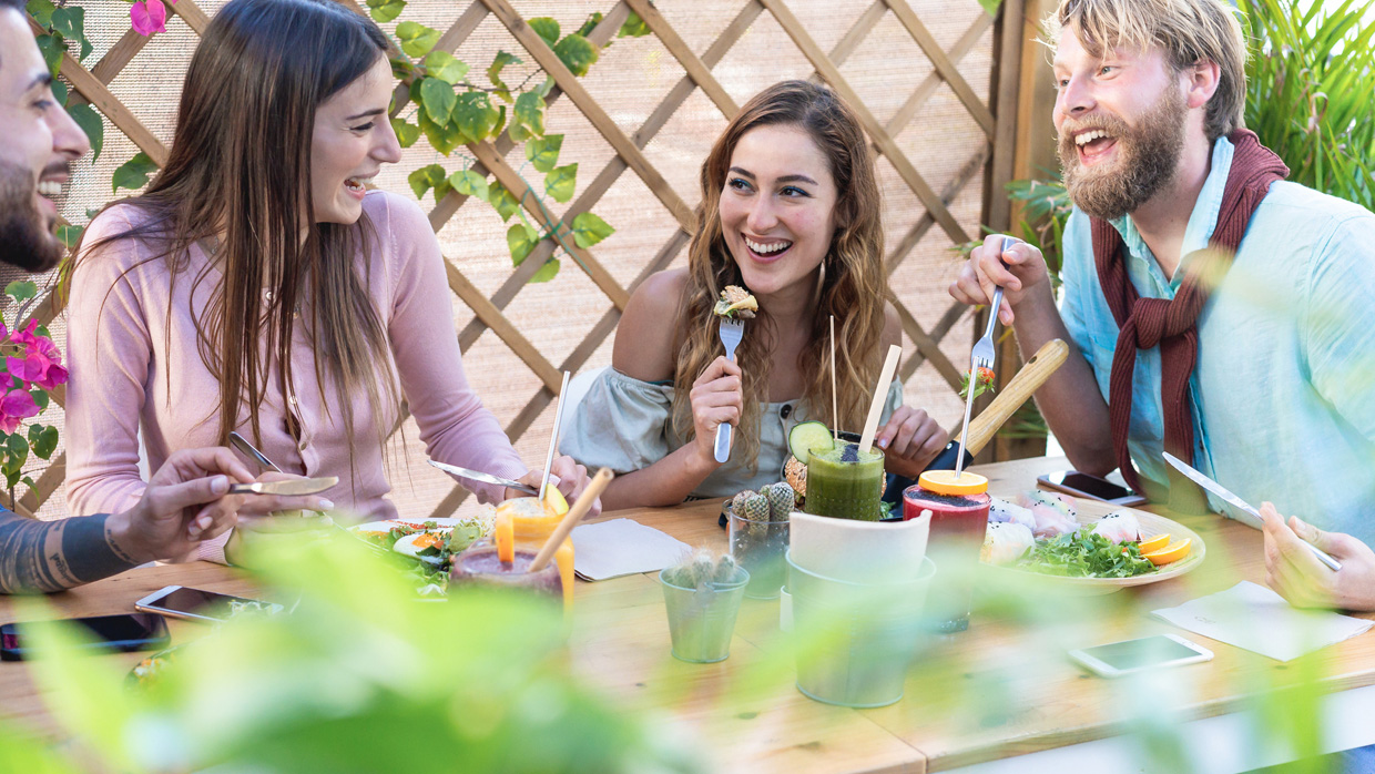 College students laughing and enjoying a healthy meal together in a vibrant setting