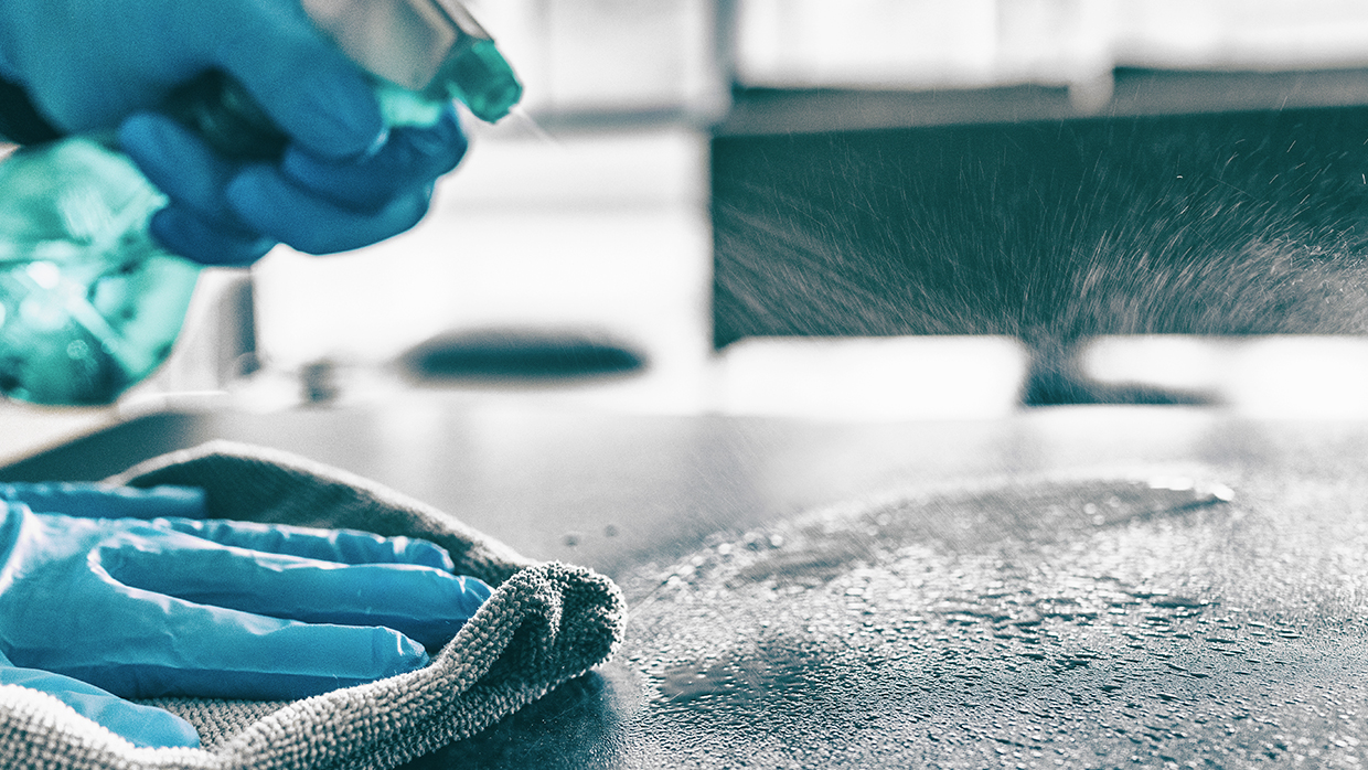 person cleaning surface