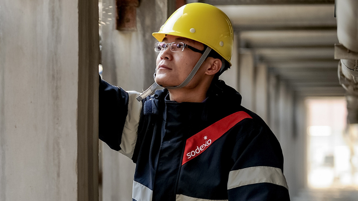 a worker looking at a wall