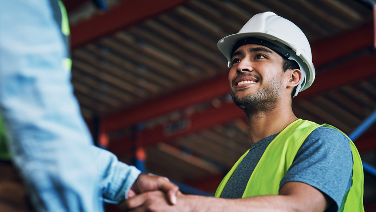 a man giving his hand to another man