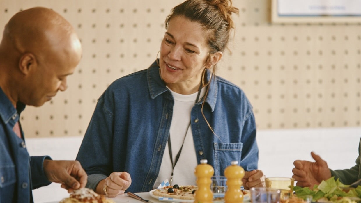 workers enjoying a meal at a table while in conversation