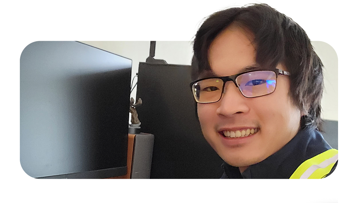 man smiling in front of a LCD screen