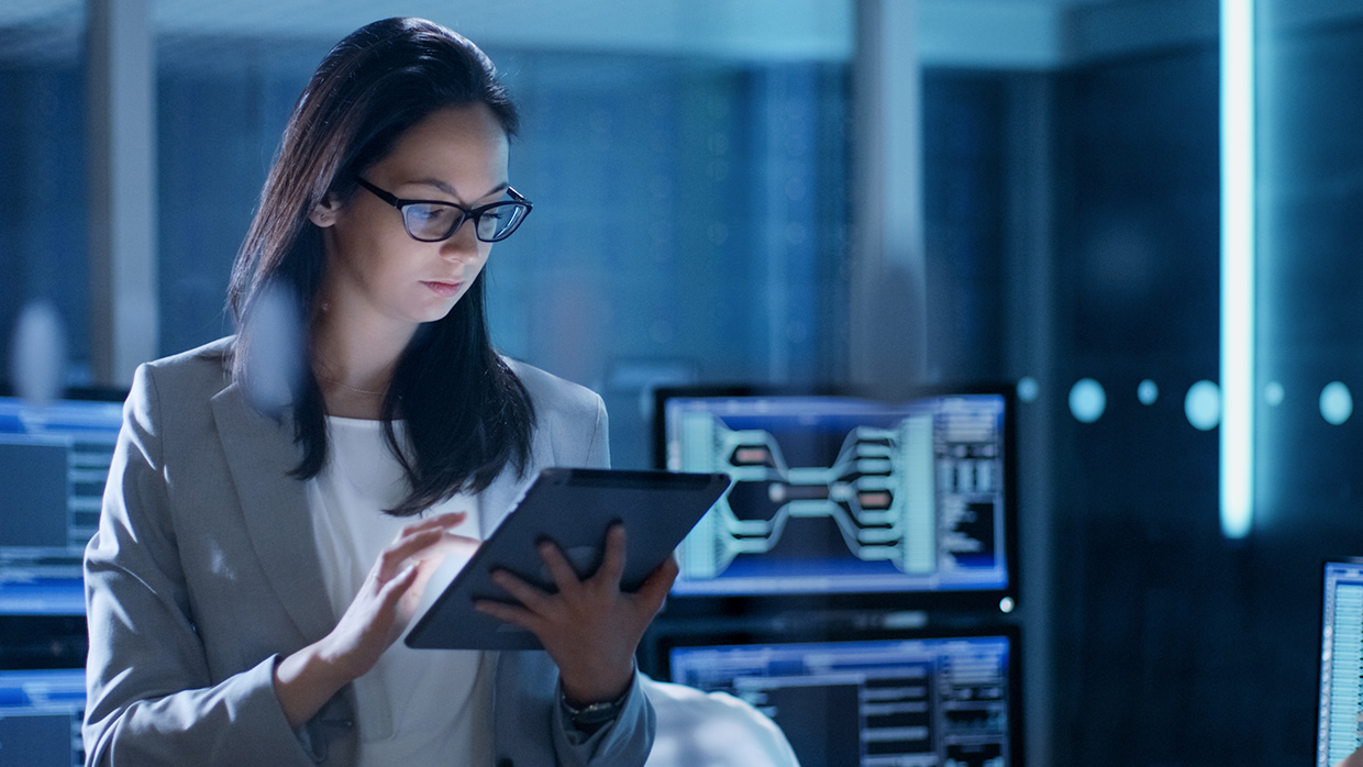 girl looking at a tablet in a technological office